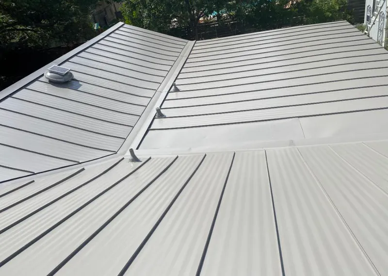 Solar attic fan installed on a metal roof for Roof Ventilation in Winnetka